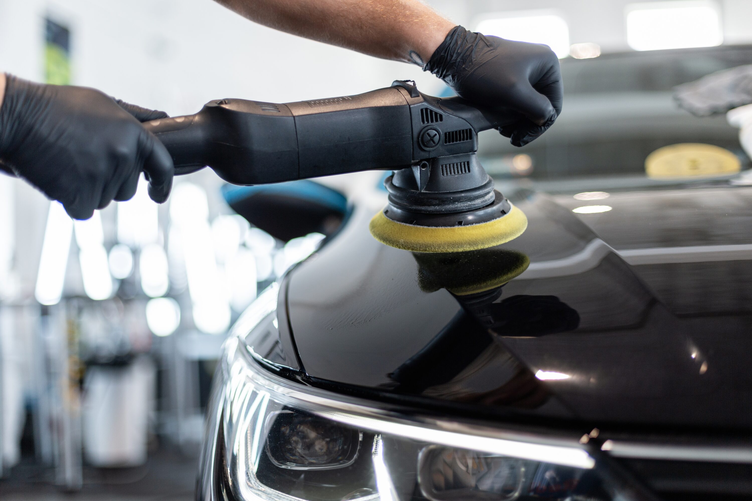 Professional,Man,With,Polishing,Tool,Polishing,Black,Car,In,Detailing